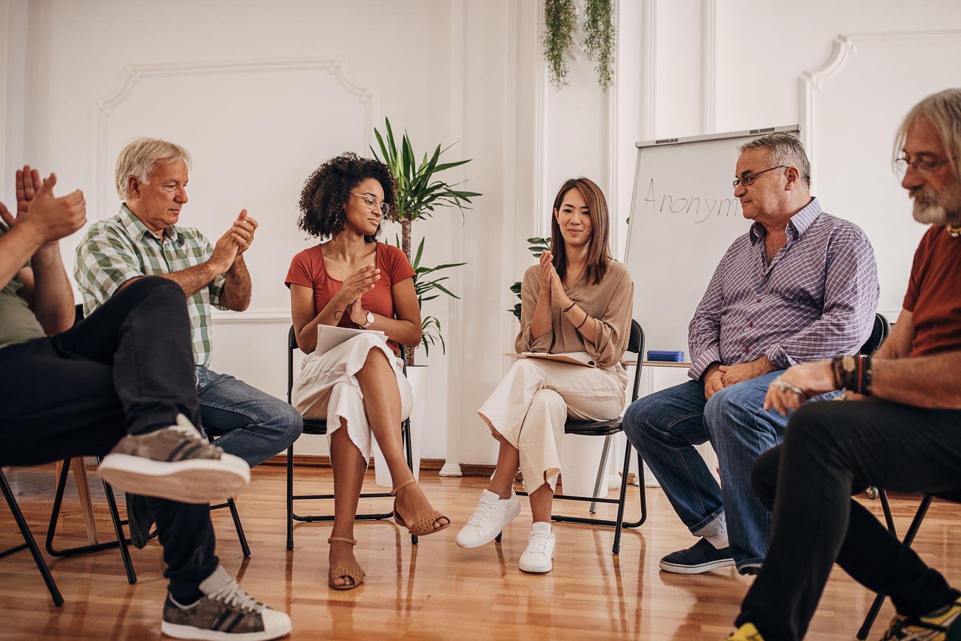People clapping at support group therapy